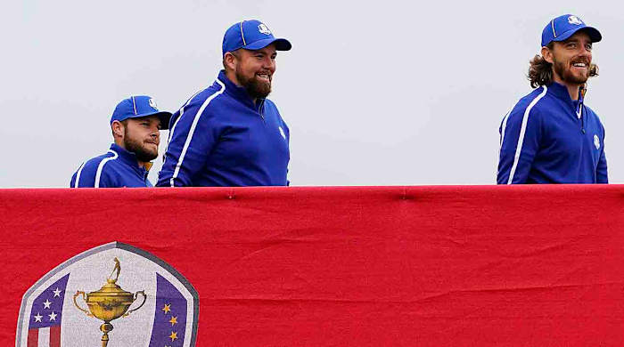 Team Europe players Tyrrell Hatton (left), Shane Lowry (center) and Tommy Fleetwood cross the bridge to the 10th tee during practice rounds for the 2021 Ryder Cup at Whistling Straits.